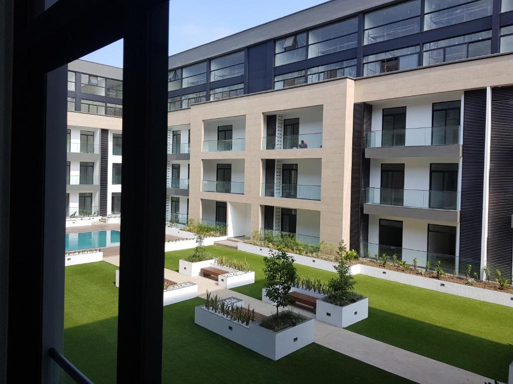 an image of an apartment building with a courtyard at Embassy Gardens Studio in Accra