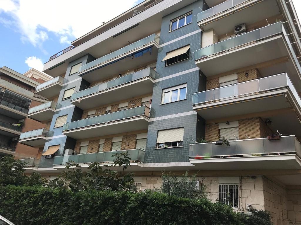 an apartment building with balconies on the side of it at AzzurRomare Flat apartment in Lido di Ostia