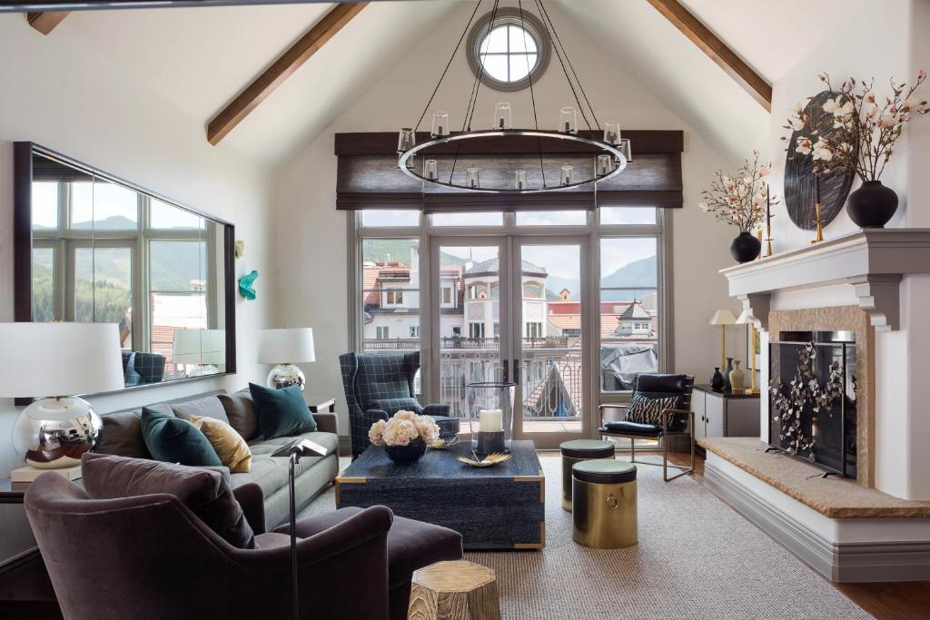 a living room with a couch and a fireplace at Pop Art Villa Vail in Vail