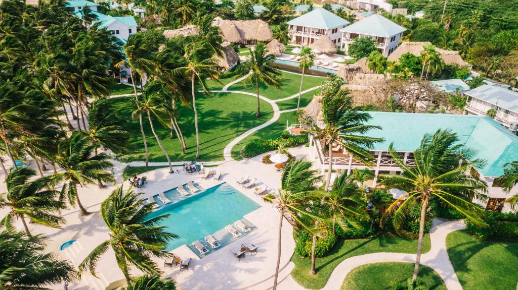an aerial view of a resort with a pool and palm trees at Victoria House Resort & Spa in San Pedro