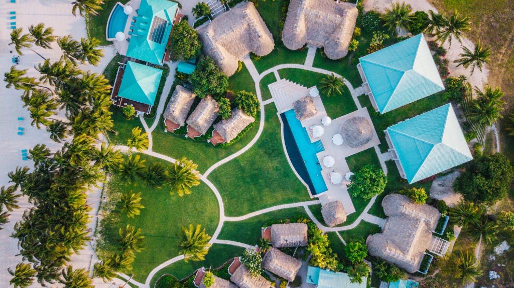 an aerial view of a resort with a pool andanas at Victoria House Resort & Spa in San Pedro