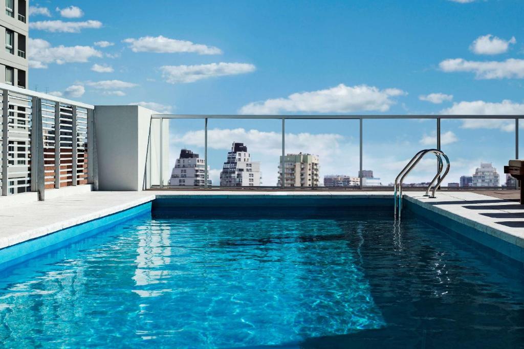 a swimming pool on the roof of a building at Dazzler by Wyndham Polo in Buenos Aires