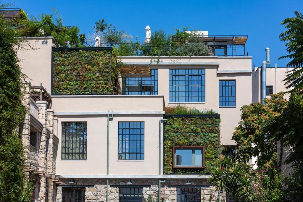 an apartment building with a green wall at The Foundry Suites in Athens