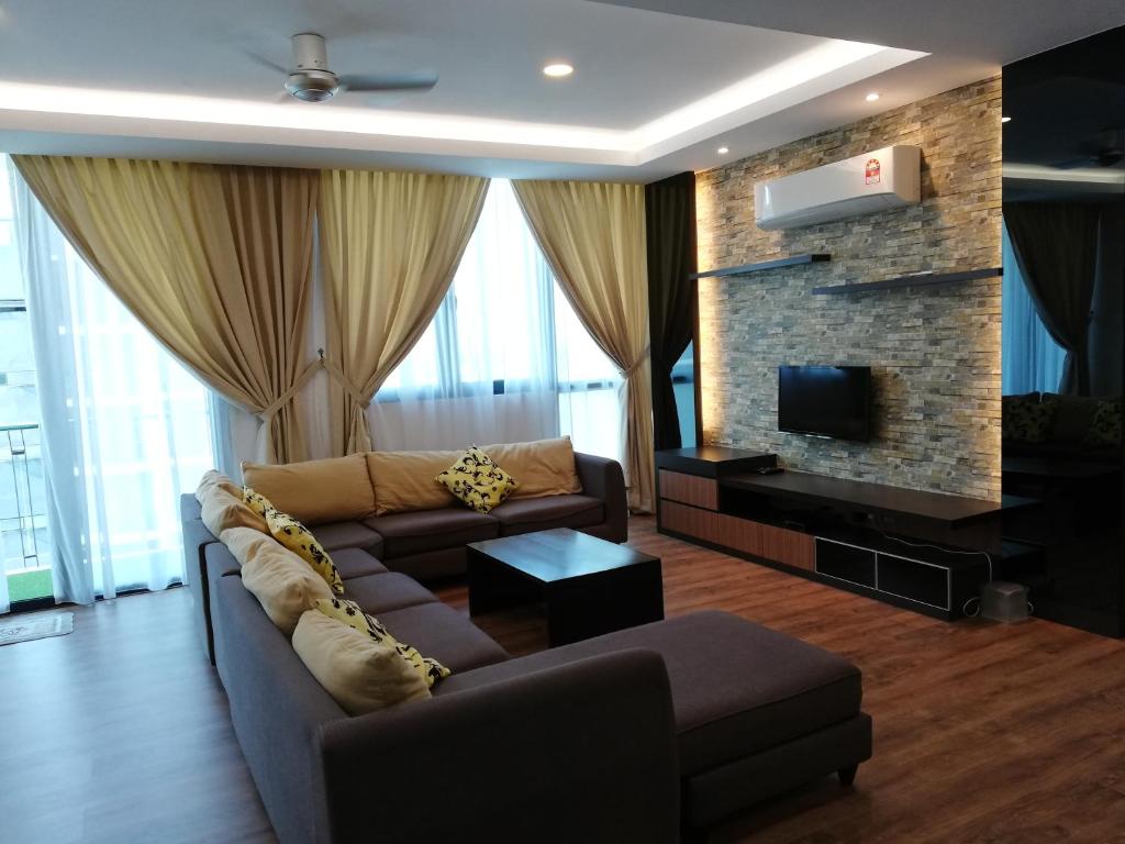 a living room with a couch and a fireplace at Vivacity jazz suite 3 condo 139 in Kuching