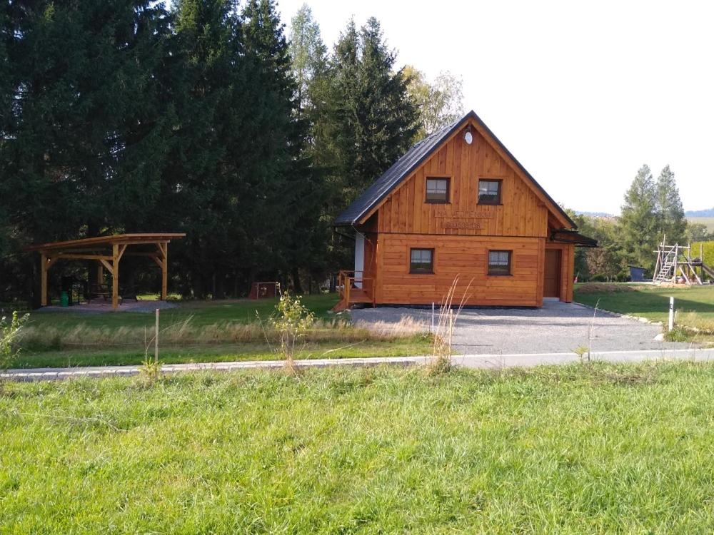 a wooden cabin with a gazebo in a field at Na Vejměnku in Dolní Morava