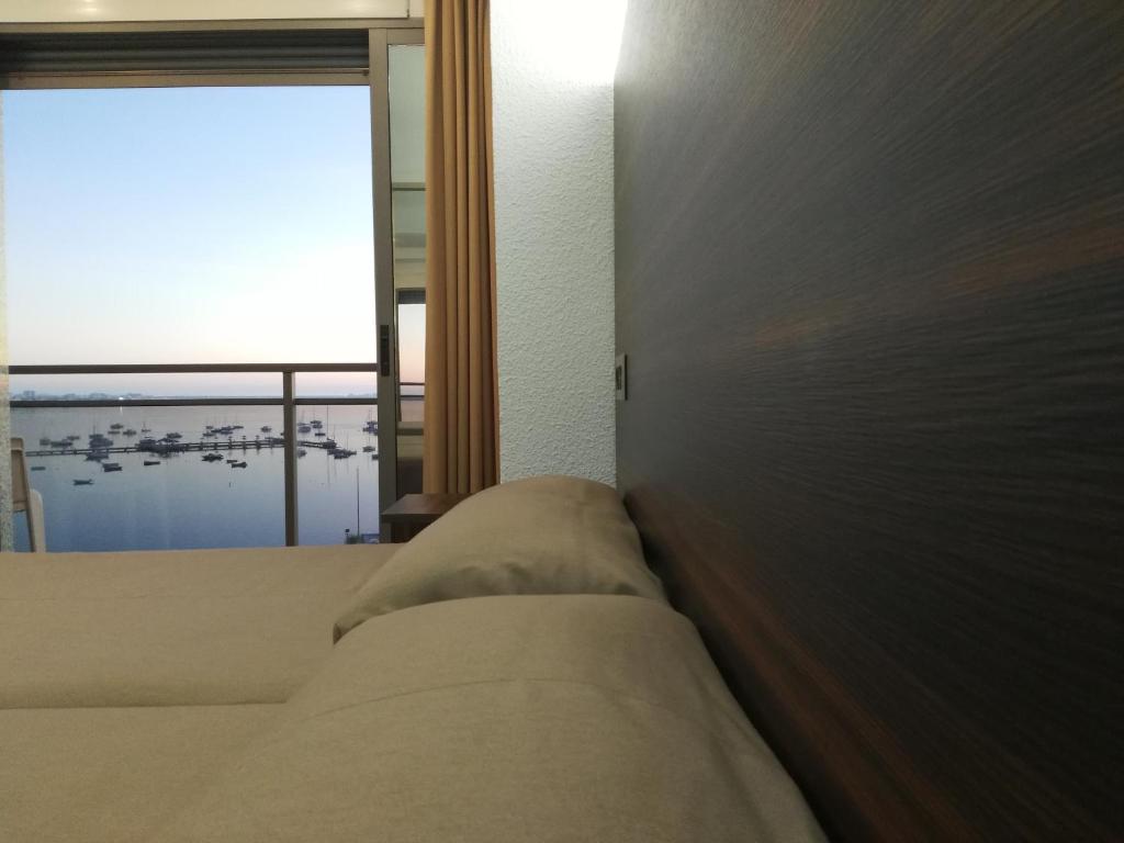 A bed or beds in a room at Hotel Ribera