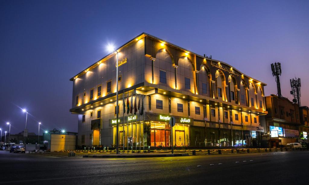 a large building with lights on the side of it at Golden Rest Hotel in Al Khobar