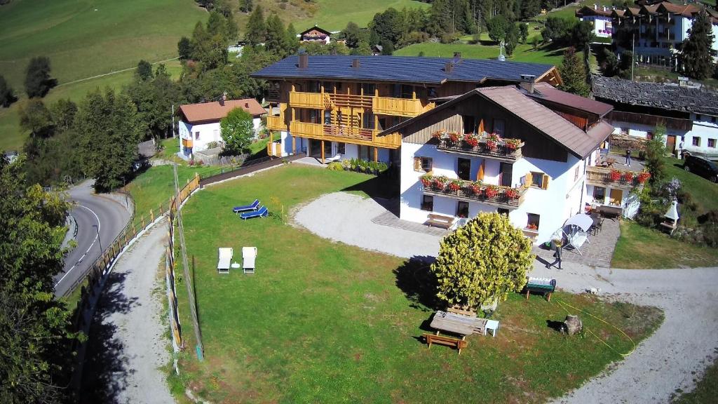 an aerial view of a large house on a hill at Pension Aichner in Terento