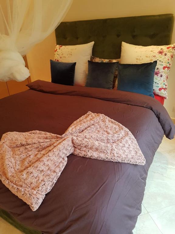 Кровать или кровати в номере Residance jardins de bouznika