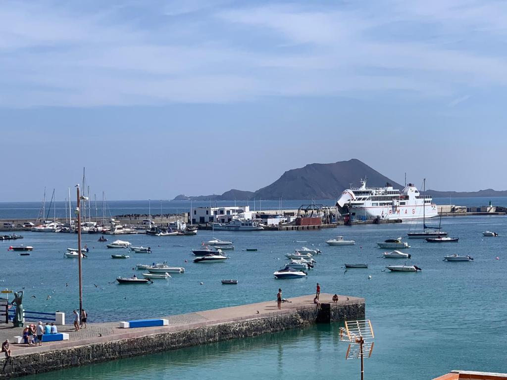 a harbor filled with lots of boats in the water at Vivienda Vacacional Casa Lina in Corralejo