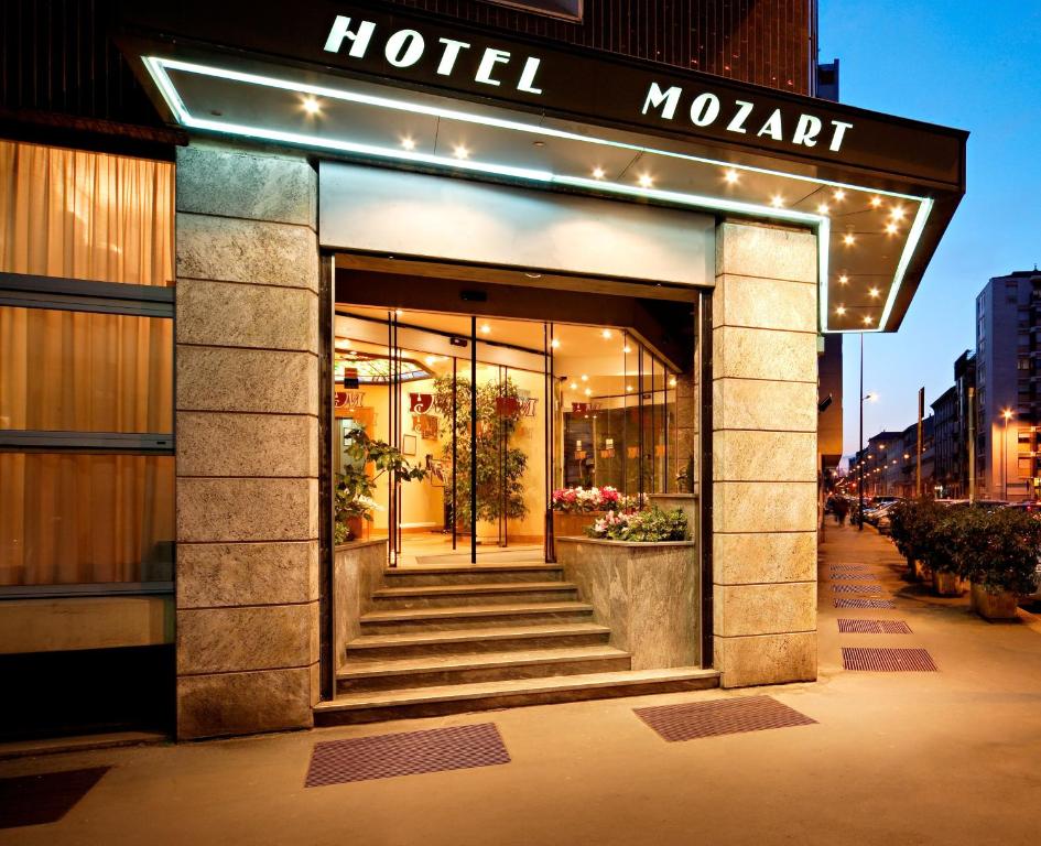 a hotel lobby with stairs leading into a building at Hotel Mozart in Milan