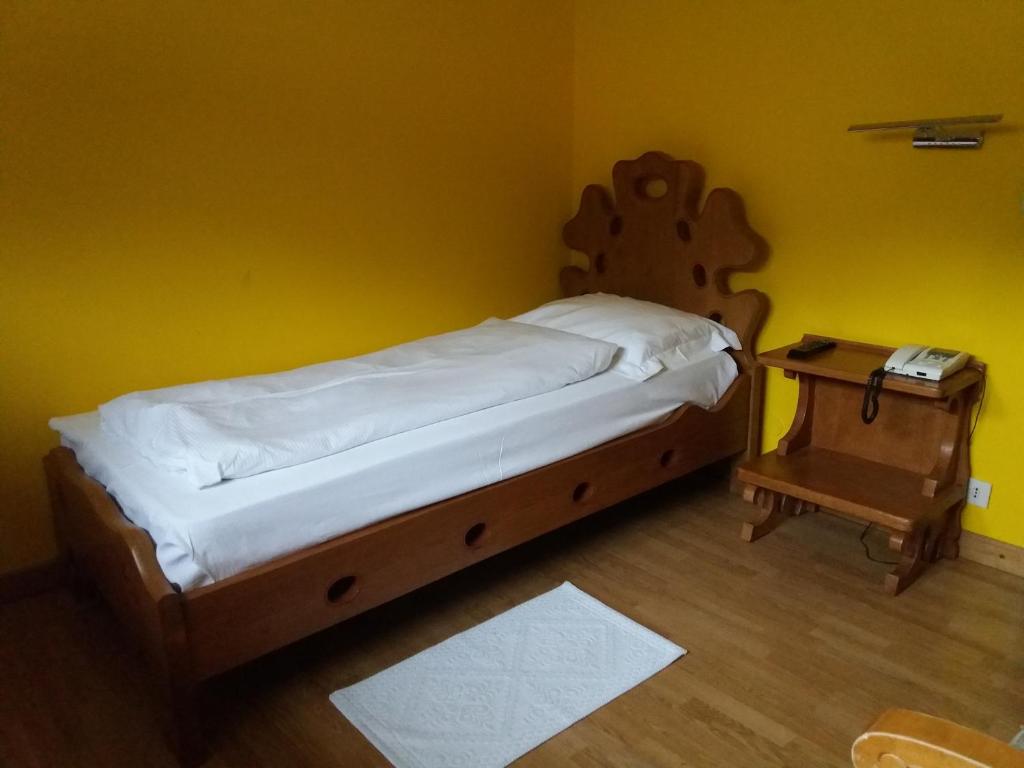 Postel nebo postele na pokoji v ubytování Hotel Cristallo