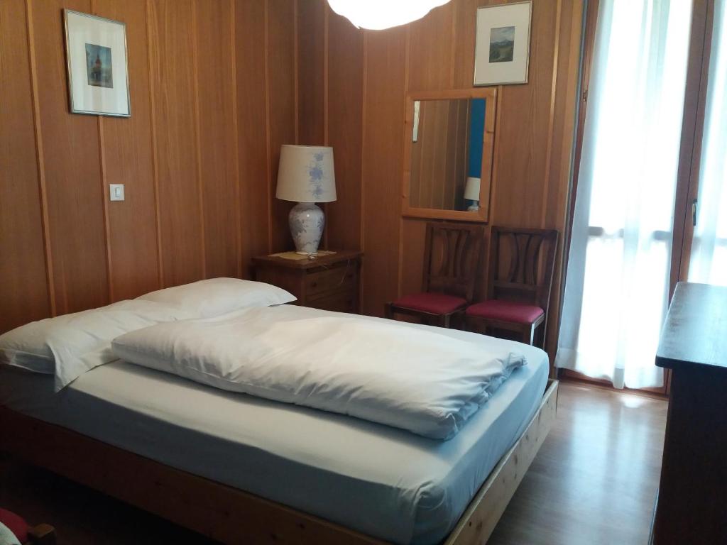 Postel nebo postele na pokoji v ubytování Hotel Cristallo