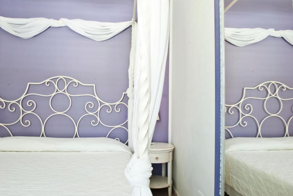 Postel nebo postele na pokoji v ubytování Hotel Mea - Aeolian Charme