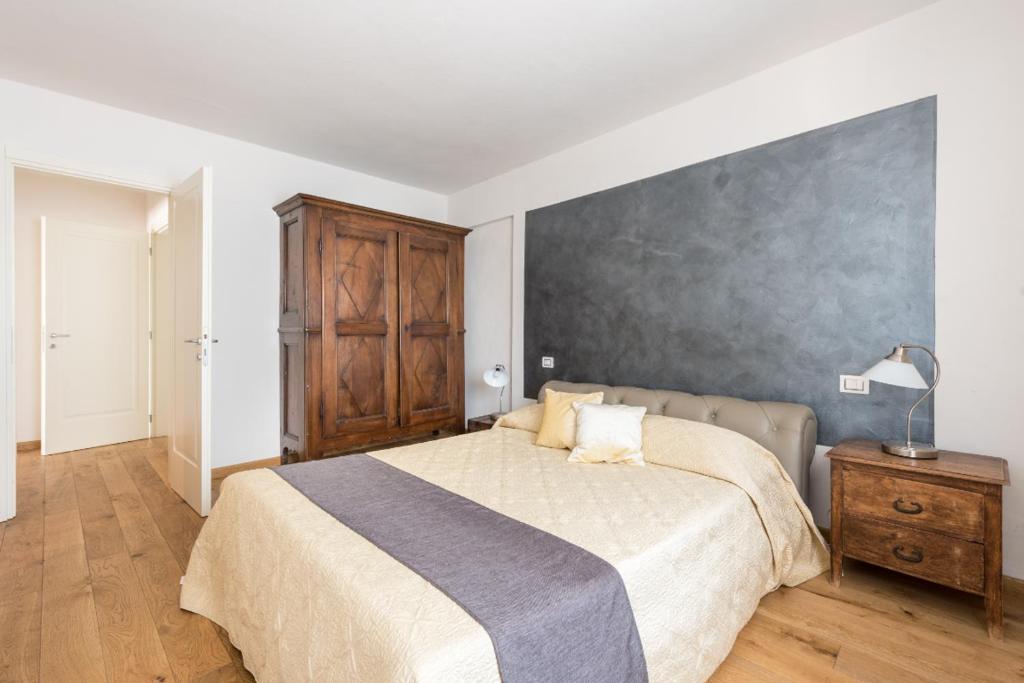 a bedroom with a large bed and a wall at Lovewknds - Topfloor with Duomo View in Florence