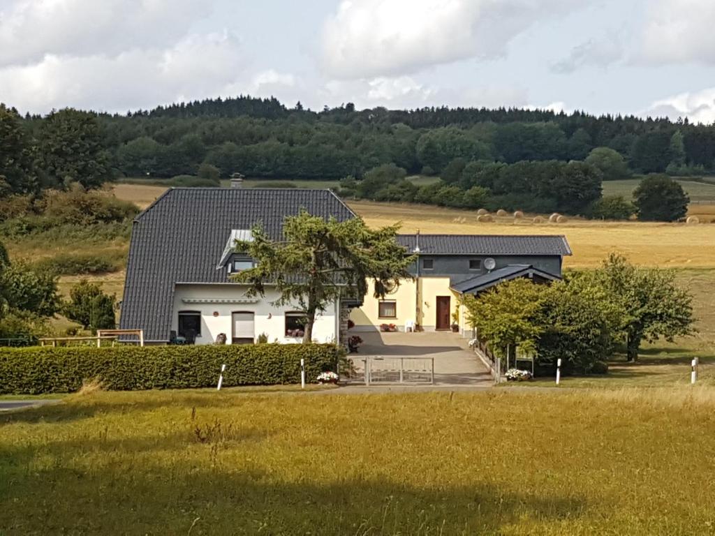 a house in the middle of a field at Nationalpark-Gastgeber Eifel in Blankenheim