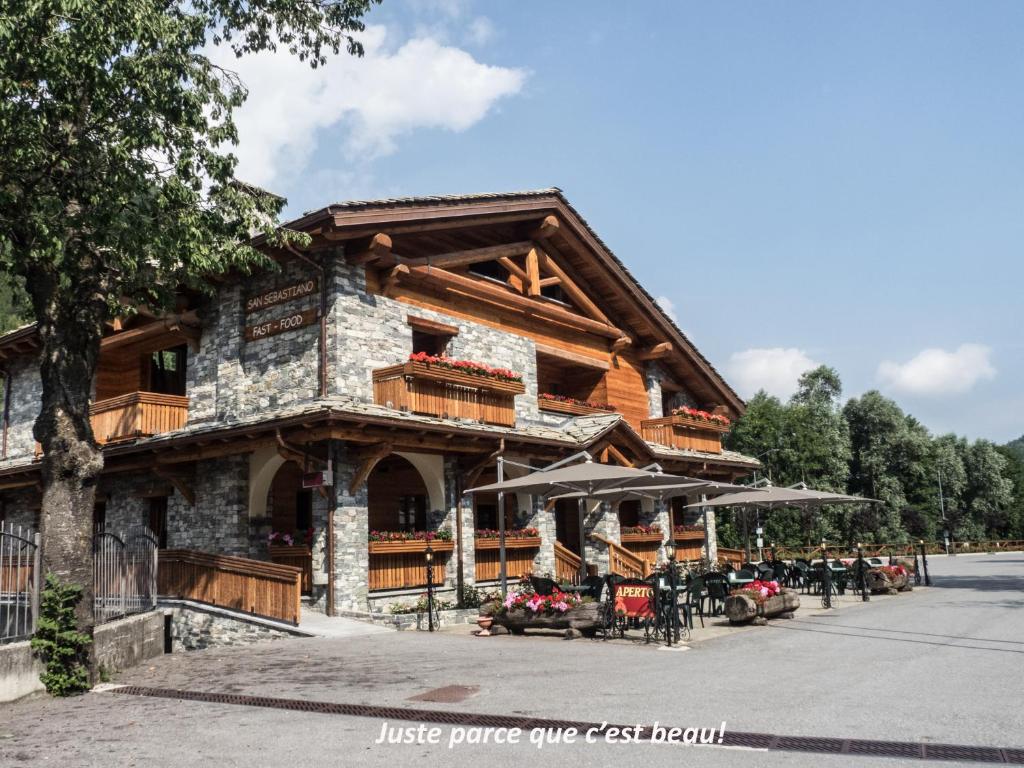 a log cabin building with motorcycles parked outside of it at B&B San Sebastiano in Vernante