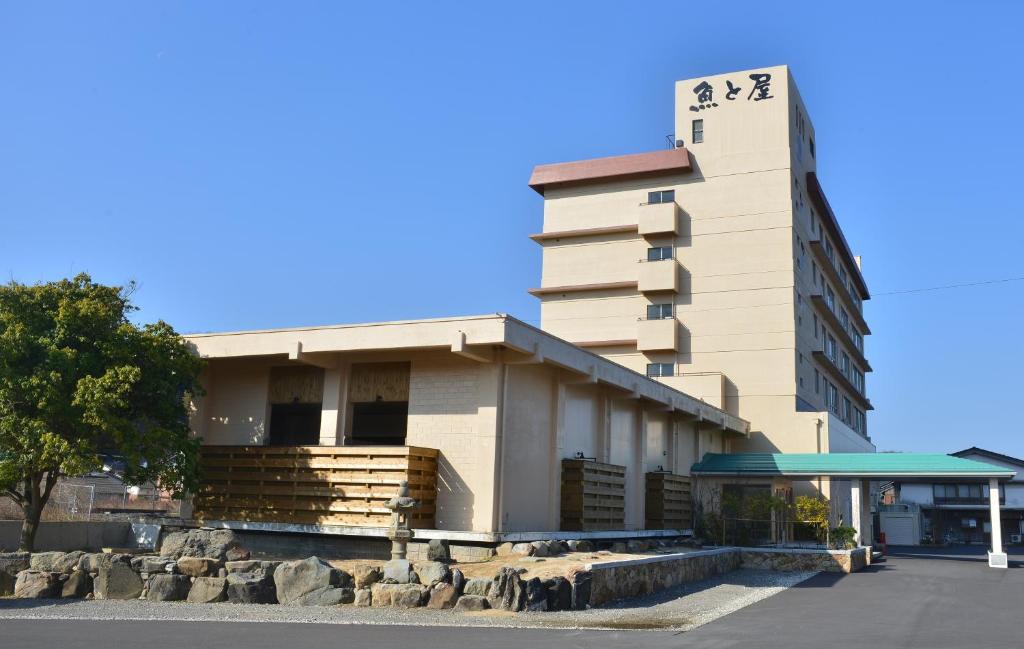 a building with a sign on top of it at Hamamura Onsen Totoya in Tottori