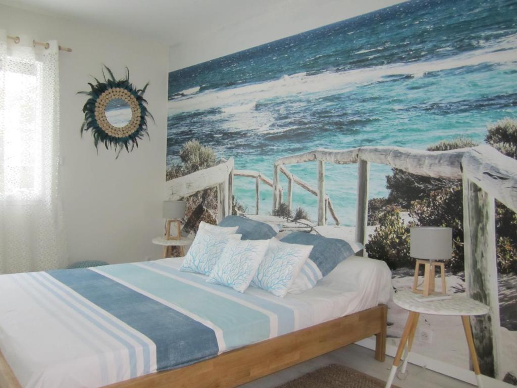 UchaudにあるLe lagon bleuのベッドルーム1室(海の絵画付)
