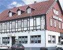 a large building with cars parked in front of it at Hotel Zum Weinberg in Cremlingen