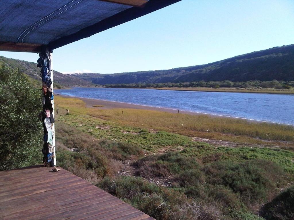 a boardwalk with a view of a body of water at Koensrust Tented River Camp in Vermaaklikheid
