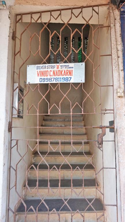 a gate to a building with a sign on it at Stay Goa Guesthouse in Madgaon