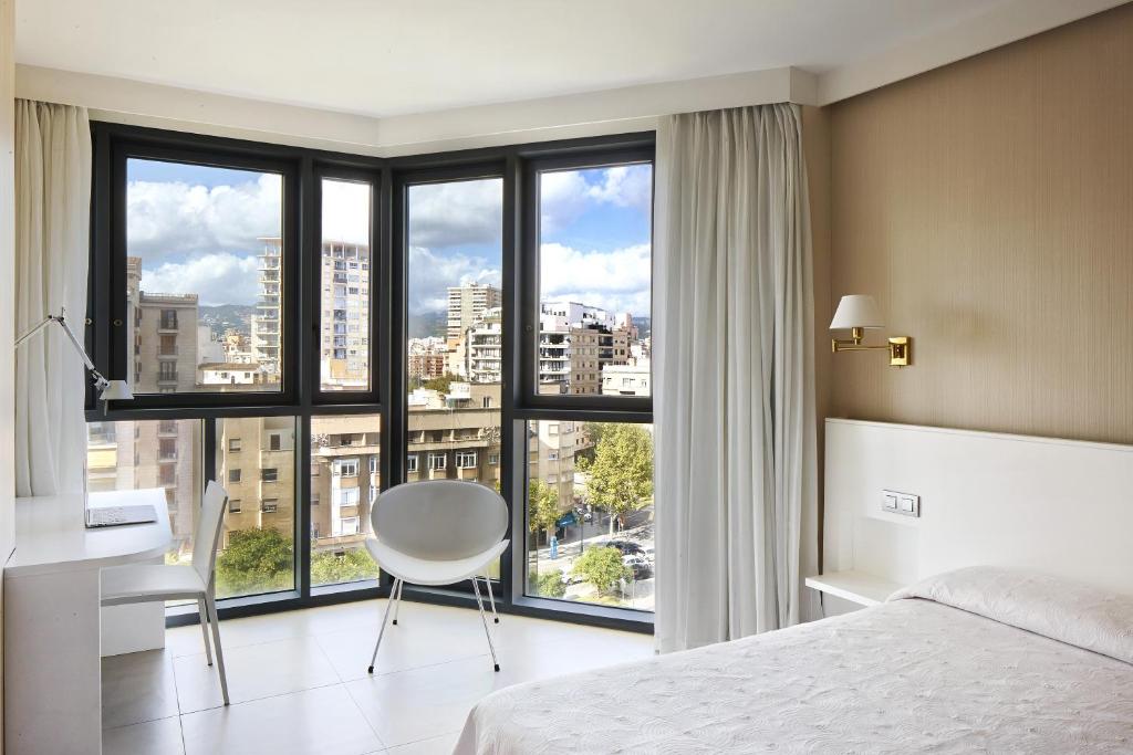 a bathroom with a large window overlooking a city at Hotel Palladium in Palma de Mallorca