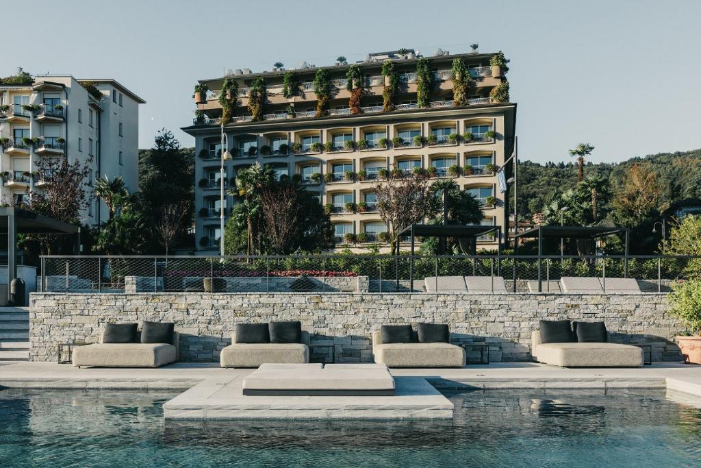 a hotel with a building in the background at Hotel La Palma in Stresa
