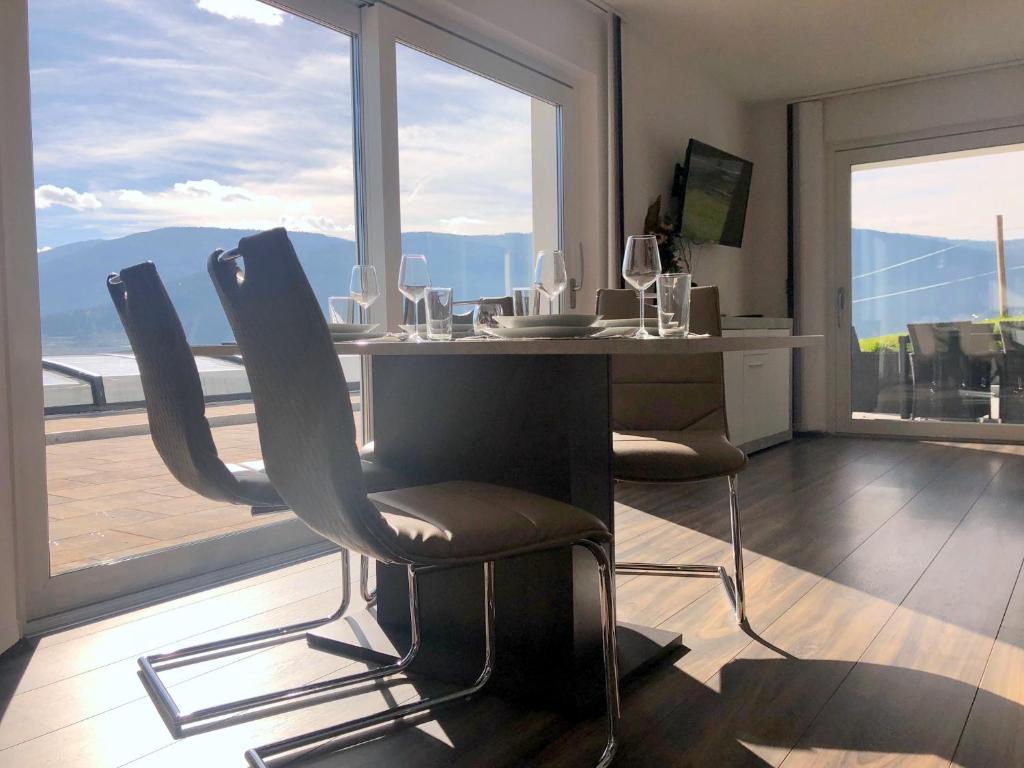 a dining room with a table with chairs and a window at Sonnseite in Sankt Margarethen im Lungau