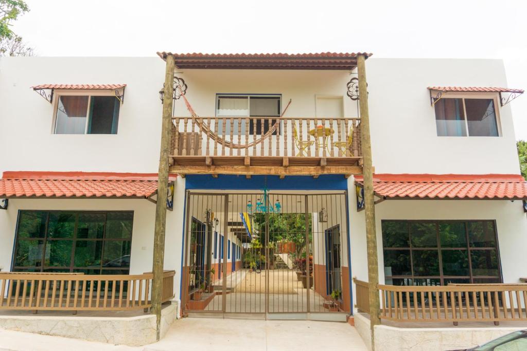 a villa with a balcony and a gate at Hacienda bambú in Bacalar