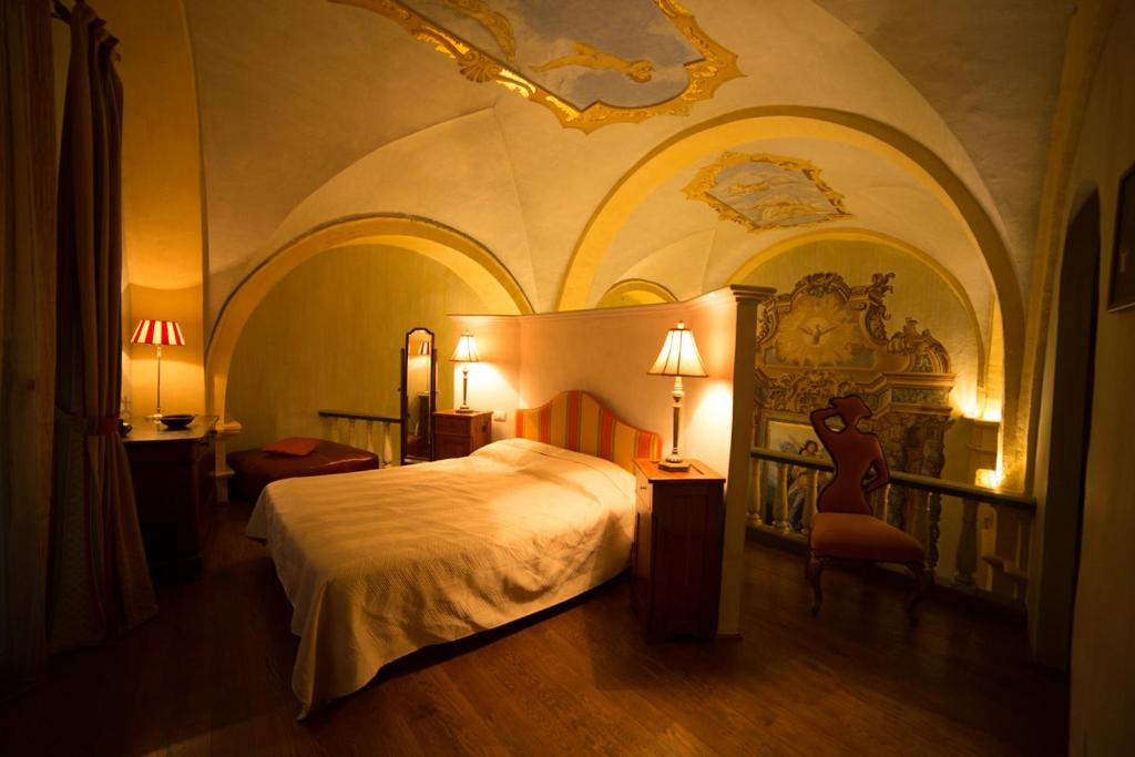 a hotel room with a bed and a chair at Palazzo Neri in Trevi