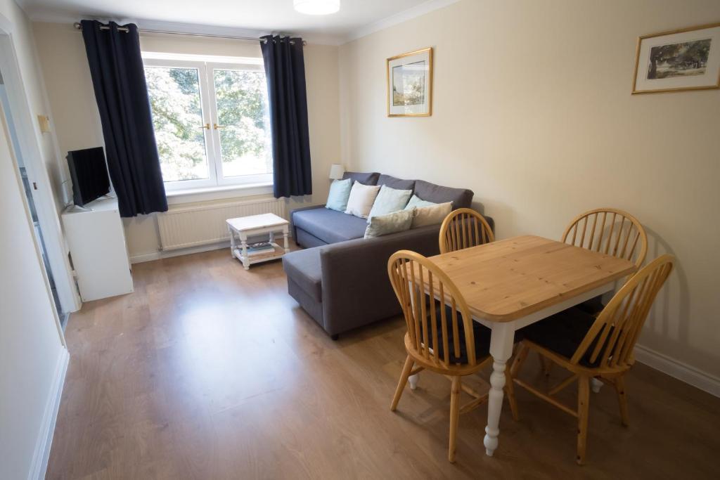 a living room with a table and a couch at Douglas Apartment in Alexandria