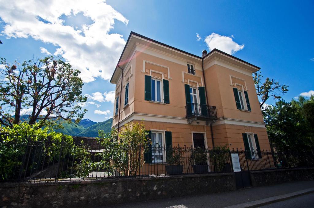 a large house with a fence in front of it at Villa Art'è in Locarno