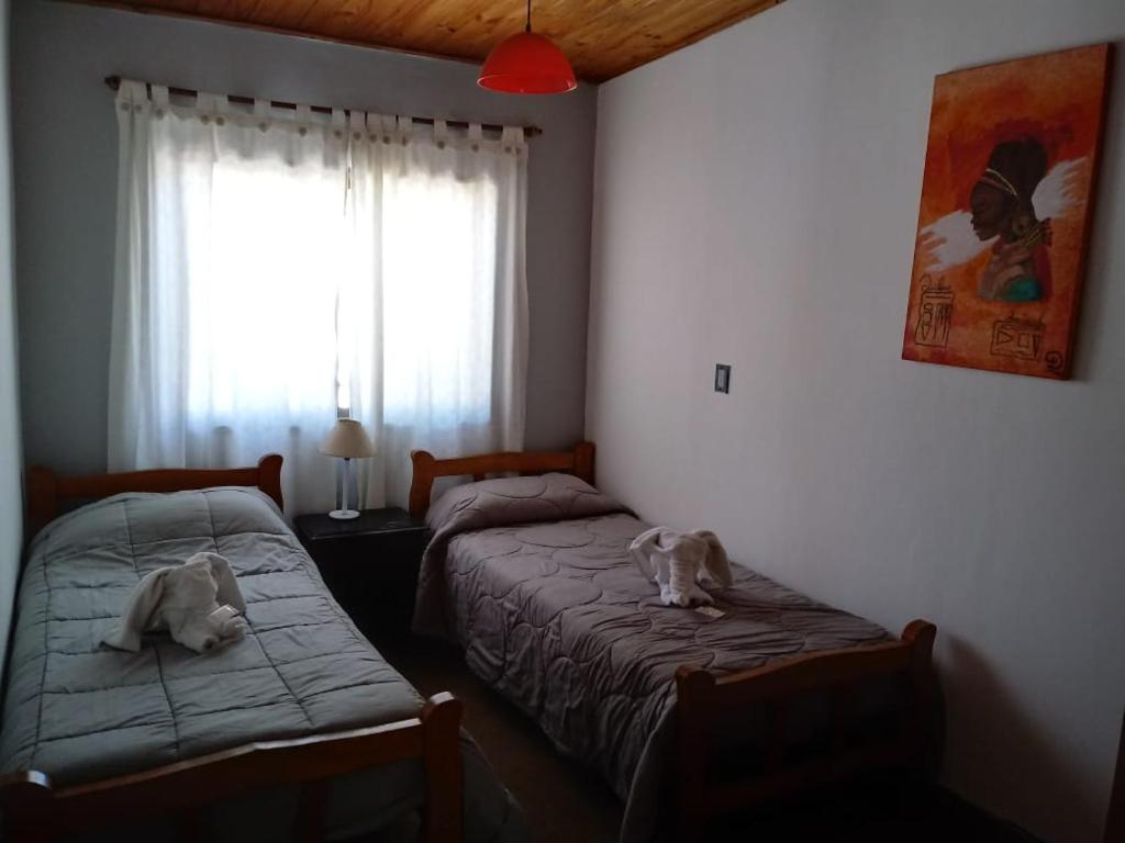 two dogs laying on beds in a bedroom at Hotel Buenavista - BV Hoteles in La Falda