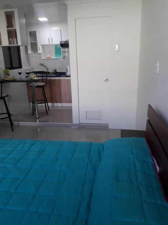 a living room with a blue rug on the floor at Mini Loft in Iquique