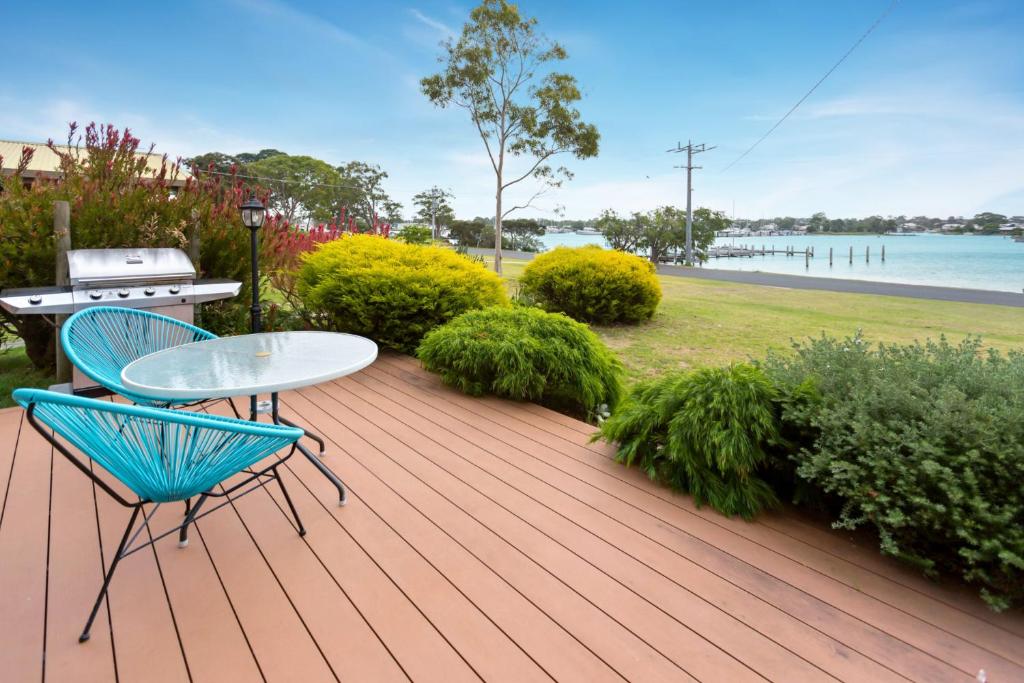 a wooden deck with a table and chairs on it at Getaway in Paynesville