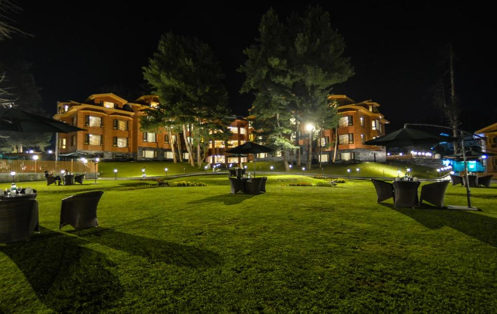 a park at night with buildings and lights at Royal Hillton Pahalgam in Pahalgām