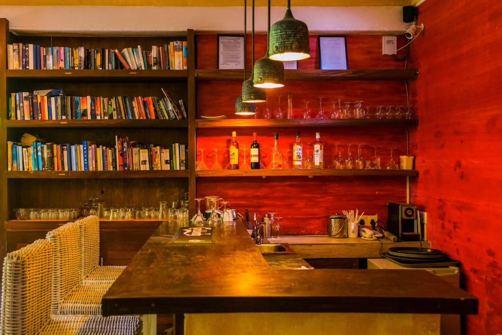 a bar with two chairs and a table in a library at Thambapanni Retreat in Unawatuna