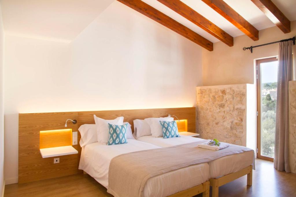 a bedroom with two beds and a large window at Angels Boutique - Turismo de interior in El Port de la Selva