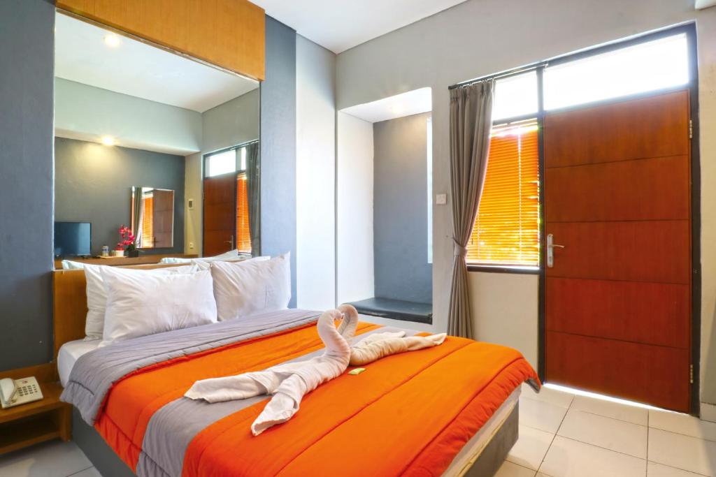 Un pat sau paturi într-o cameră la Sayang Residence 2