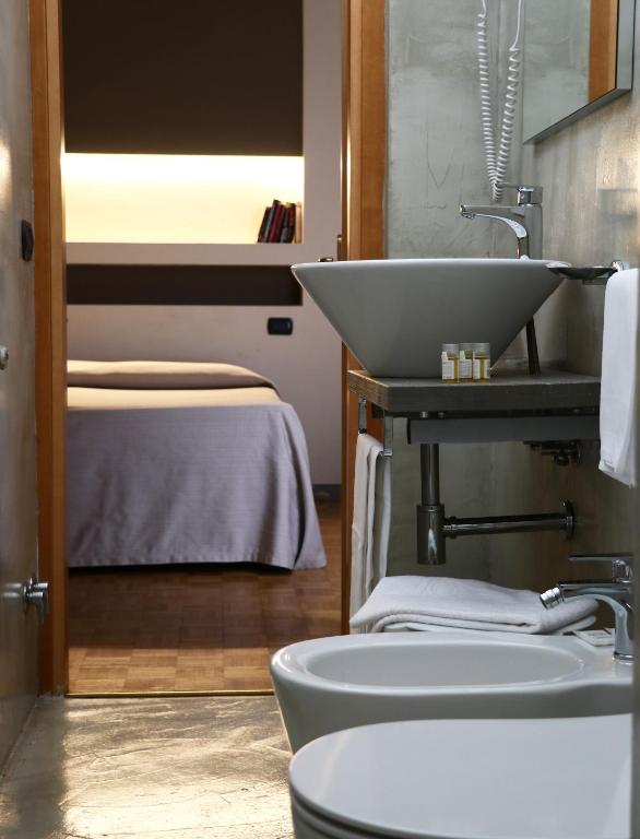 Postel nebo postele na pokoji v ubytování Hotel Clarici