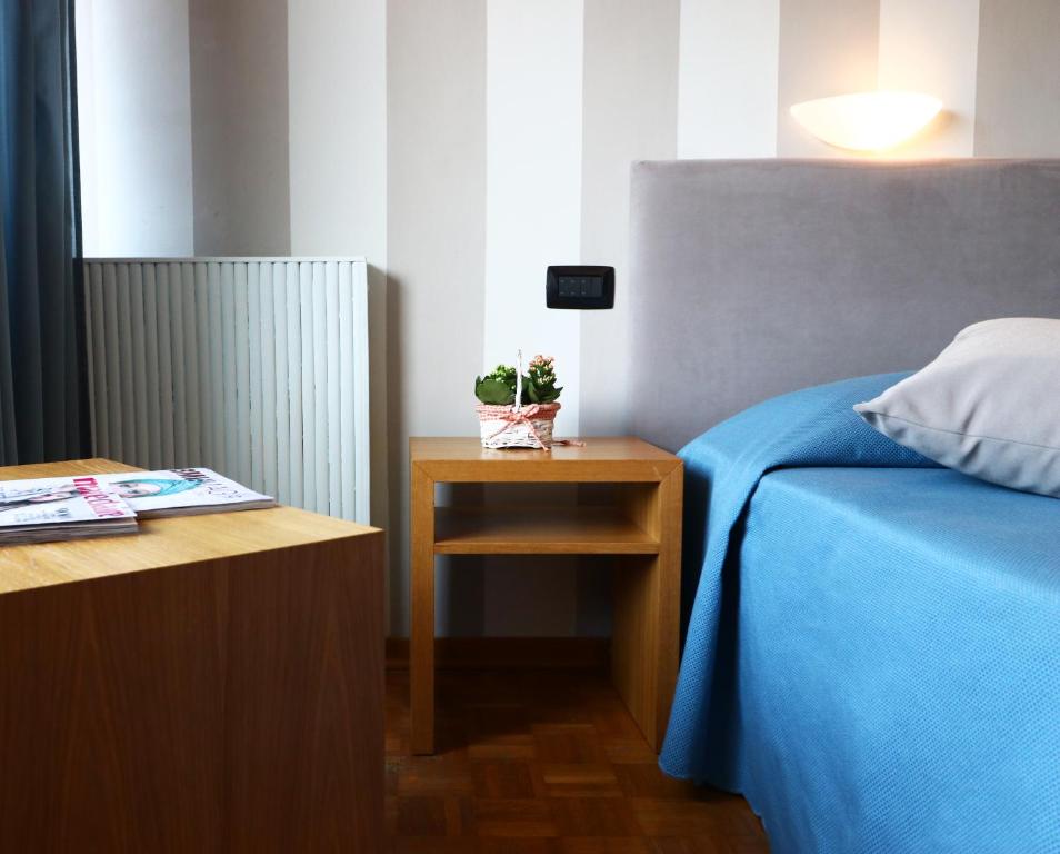 Postel nebo postele na pokoji v ubytování Hotel Clarici