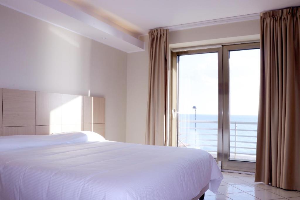 Postel nebo postele na pokoji v ubytování Hotel Ancora