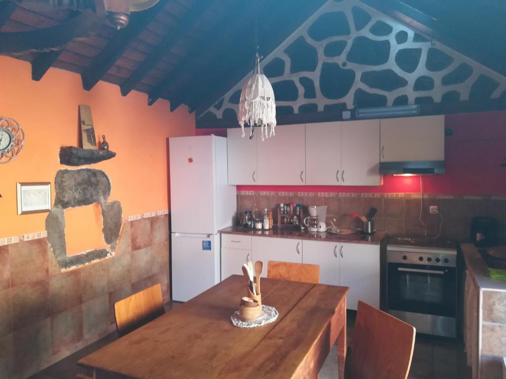 a kitchen with a wooden table in a room at Casa Mamánena in Mogán