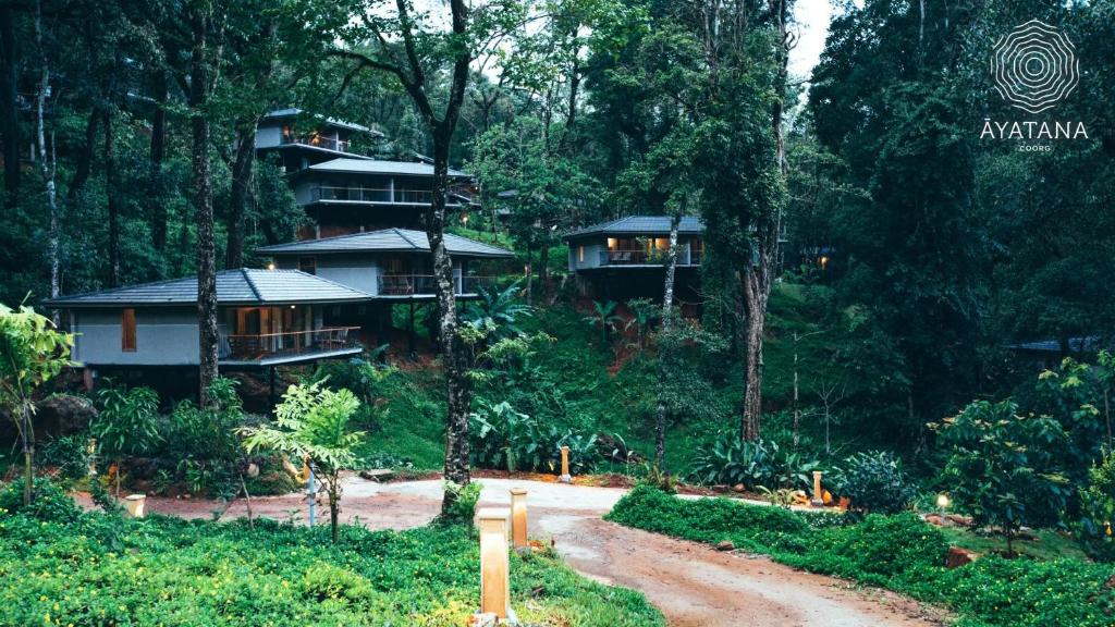 a house in the middle of a forest at WelcomHeritage Ayatana, Coorg in Somvārpet