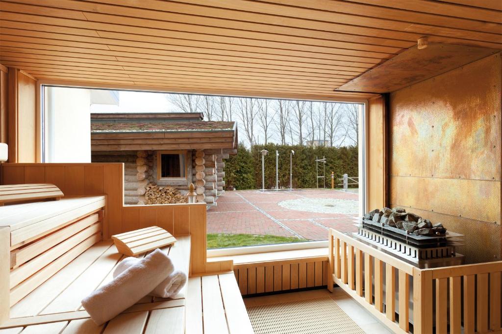 a large window in a room with a fireplace at Morada Strandhotel Ostseebad Kühlungsborn in Kühlungsborn