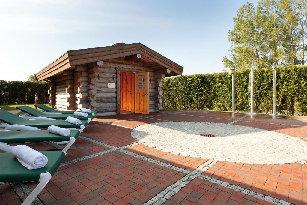a row of lounge chairs in front of a building at Morada Strandhotel Ostseebad Kühlungsborn in Kühlungsborn