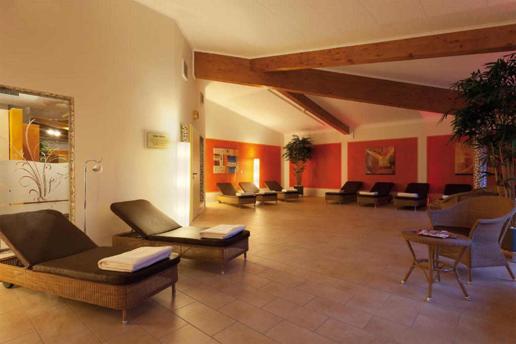 a waiting room with couches and chairs in a building at Morada Strandhotel Ostseebad Kühlungsborn in Kühlungsborn
