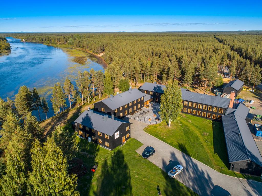 an aerial view of a resort with a river at Arctic River Lodge in Tärendö