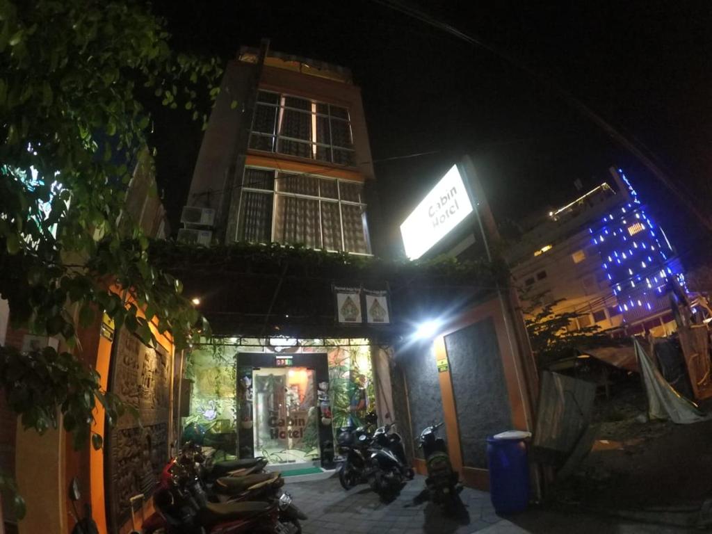 a group of motorcycles parked outside of a building at night at The Cabin Hotel in Yogyakarta